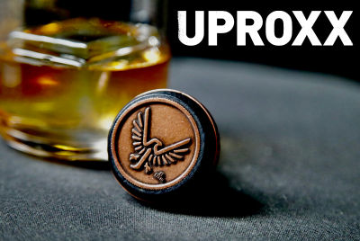 uproxx name with glass of whiskey and topper